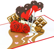 PopLife Pop-up card features sweet chocolates, heart lollipop coated with chocolate and red roses