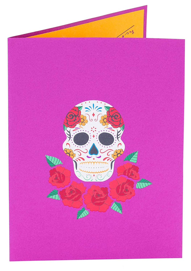 Front cover of card with purple color features colorful sugar skull with flowers