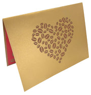 Front cover of card with gold color features coffee bean in the shape of a heart