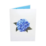 Front cover of card with light gray color features blue hydrangea flower