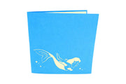 6 inches by 6 inches blue card with a swimming mermaid cutout