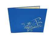 Front cover of card with blue color features flying bi-plane