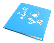 Front cover of card with blue color features bird on a branch 